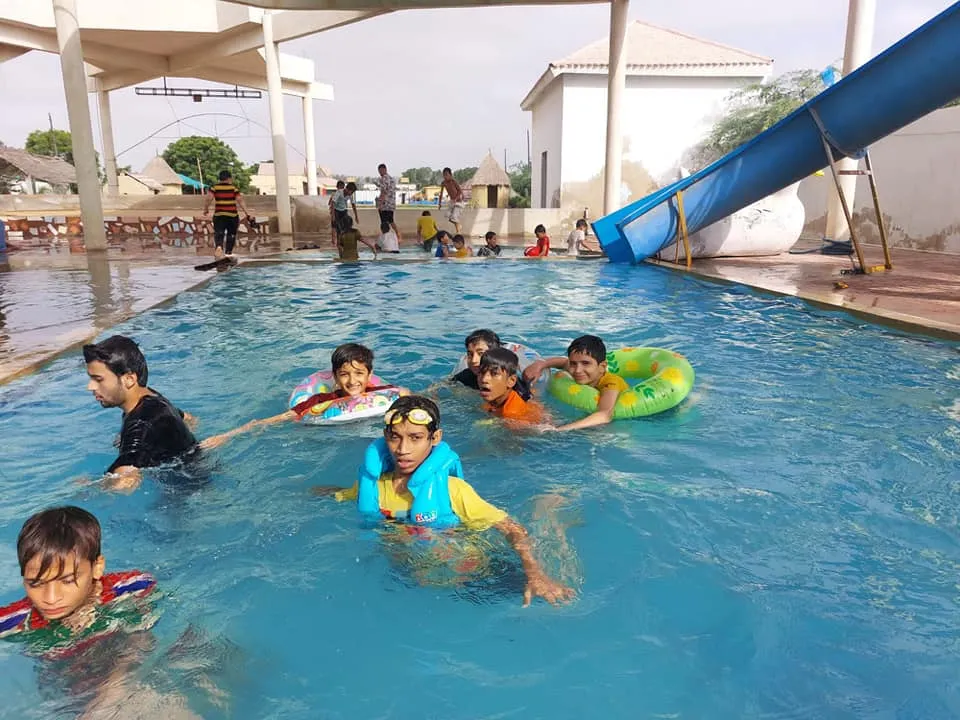 Students enjoying the pool at the annual picnic